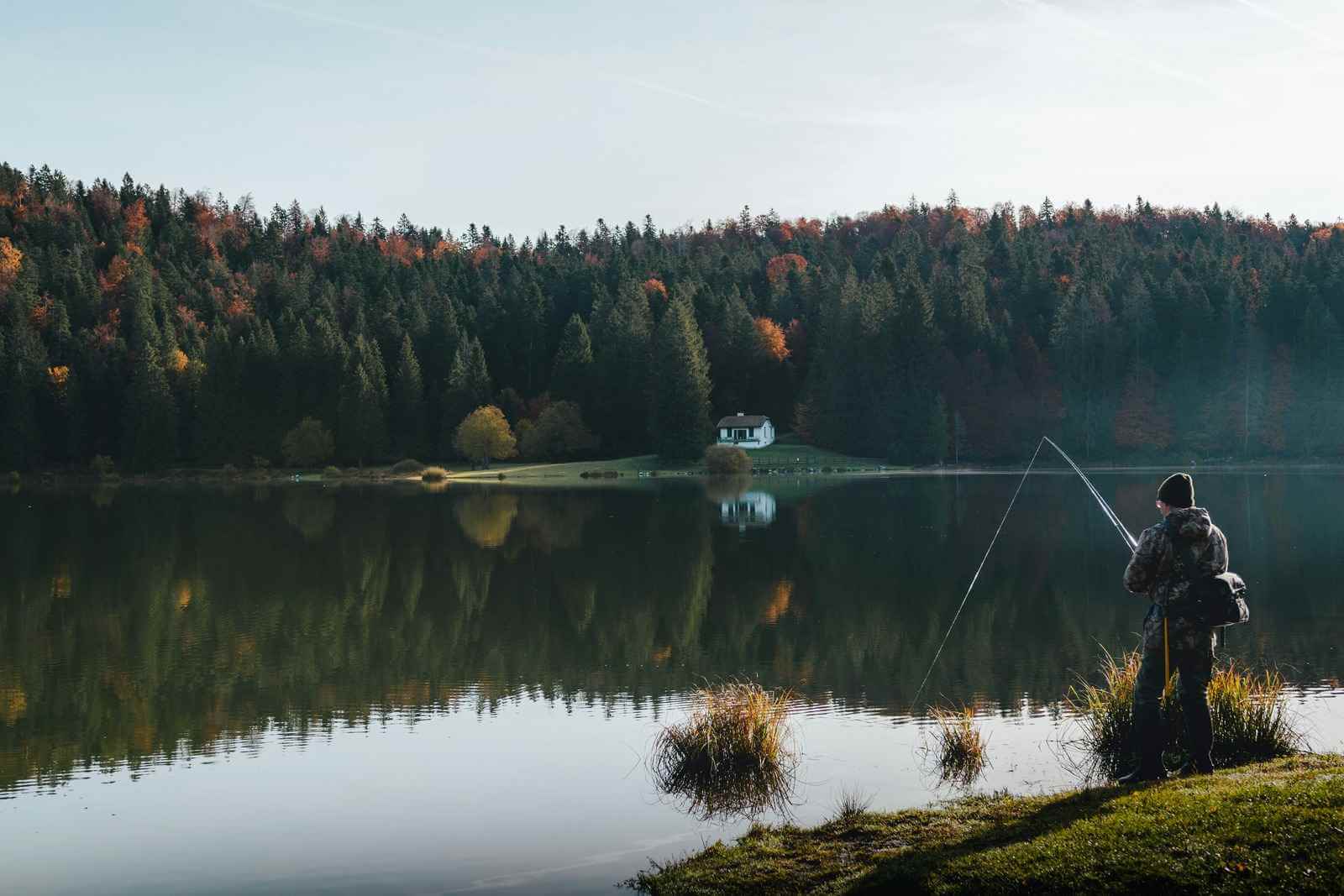 Angler fishing from a boat at sunset on a Canadian lake