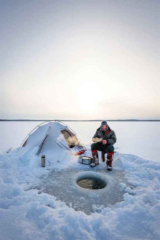 Angler fishing from a boat at sunset on a Canadian lake