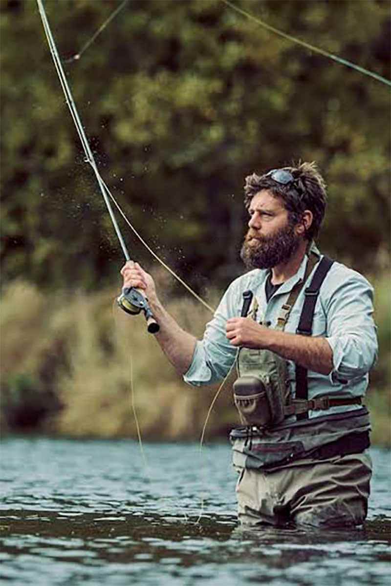 Community manager Phoenix Baker talking with members at a lakeside meetup