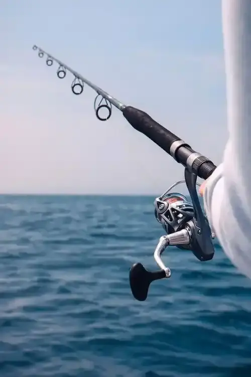 Angler fishing from a boat at sunset on a Canadian lake