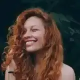 Member David Silva on a boat with fishing gear, smiling at the camera