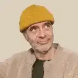 Member Lyle Kauffman sitting at a camp chair near a Canadian lake at sunset
