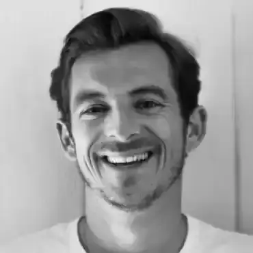 Guy Hawkins smiling with a large northern pike caught at a Canadian fishing event