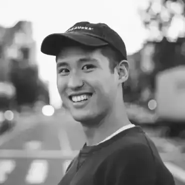 Floyd Miles standing in waders in a river after winning a trout challenge